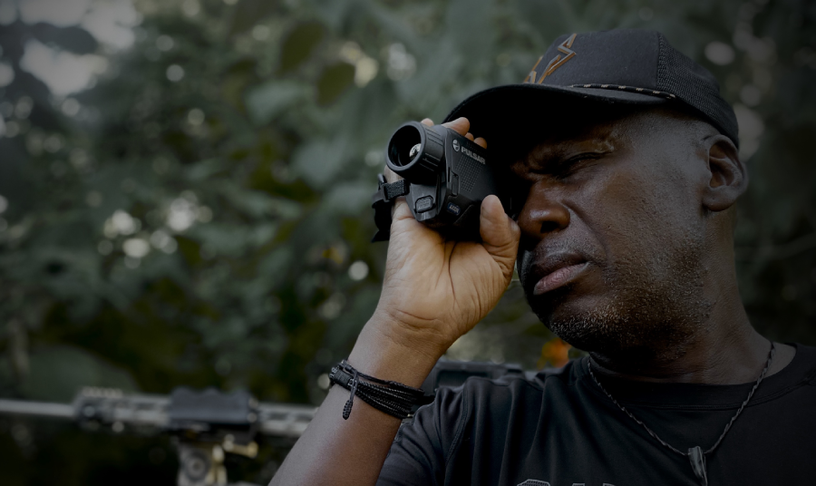 Hunter looking through handheld thermal monocular